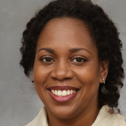 Joyful black adult female with long  brown hair and brown eyes