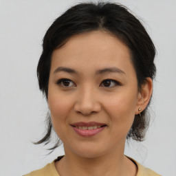 Joyful asian young-adult female with medium  brown hair and brown eyes