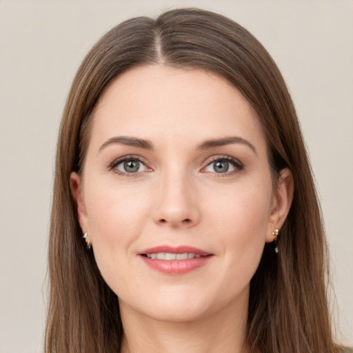 Joyful white young-adult female with long  brown hair and grey eyes