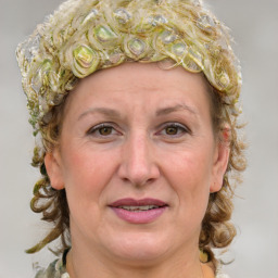 Joyful white adult female with medium  brown hair and blue eyes