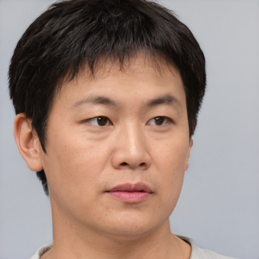 Neutral asian young-adult male with short  brown hair and brown eyes