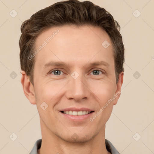 Joyful white adult male with short  brown hair and grey eyes