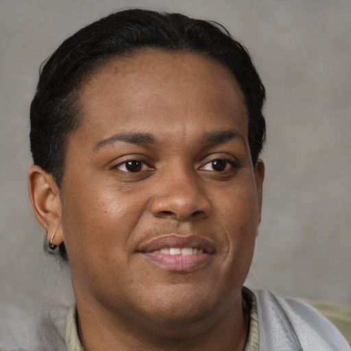 Joyful black young-adult male with short  brown hair and brown eyes