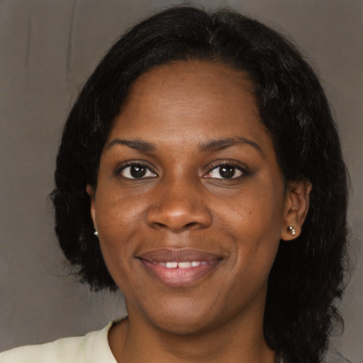 Joyful black young-adult female with medium  black hair and brown eyes