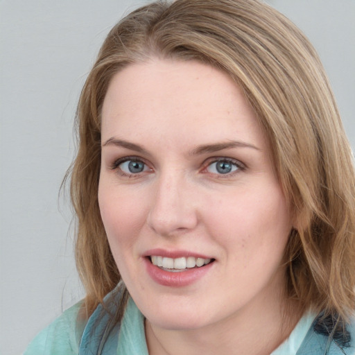 Joyful white young-adult female with medium  brown hair and blue eyes