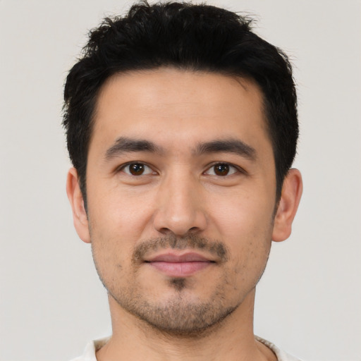 Joyful asian young-adult male with short  black hair and brown eyes