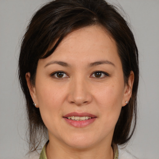 Joyful white young-adult female with medium  brown hair and brown eyes