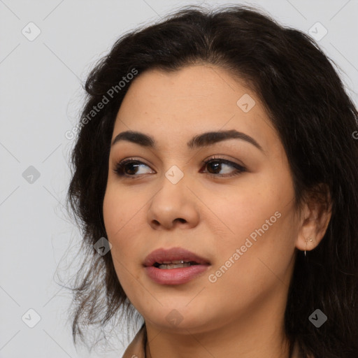 Joyful latino young-adult female with long  brown hair and brown eyes