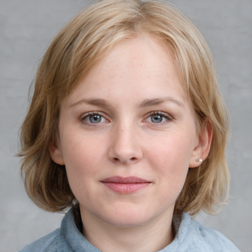 Joyful white young-adult female with medium  brown hair and blue eyes