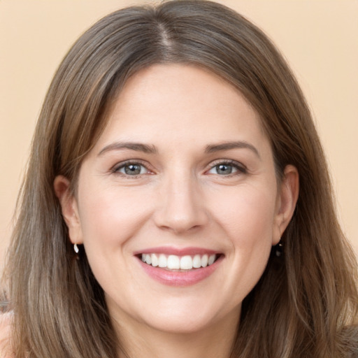 Joyful white young-adult female with long  brown hair and grey eyes