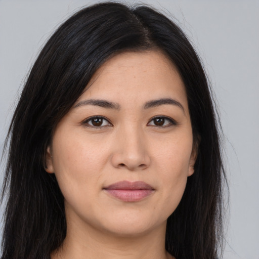 Joyful asian young-adult female with long  brown hair and brown eyes