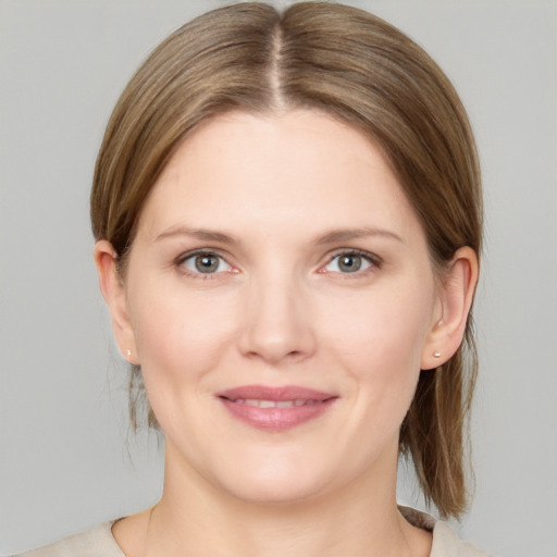 Joyful white young-adult female with medium  brown hair and grey eyes