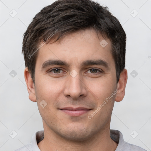 Joyful white young-adult male with short  black hair and brown eyes