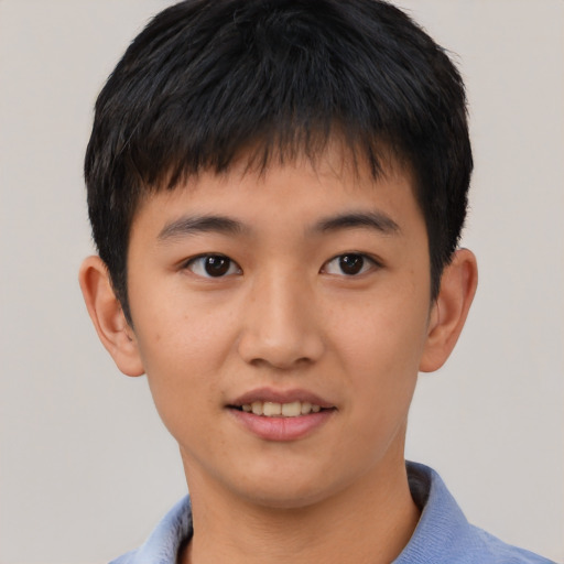 Joyful asian child male with short  brown hair and brown eyes