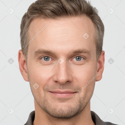 Joyful white adult male with short  brown hair and grey eyes