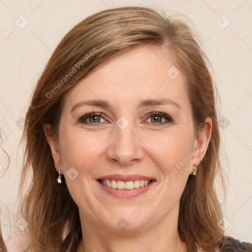 Joyful white adult female with long  brown hair and brown eyes