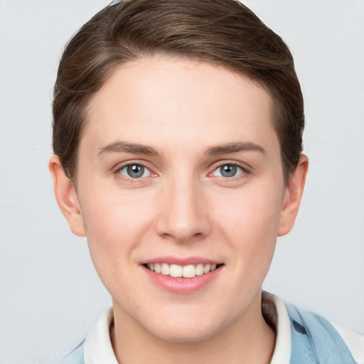 Joyful white young-adult female with short  brown hair and grey eyes