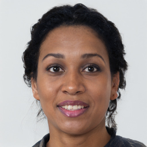 Joyful black young-adult female with medium  brown hair and brown eyes