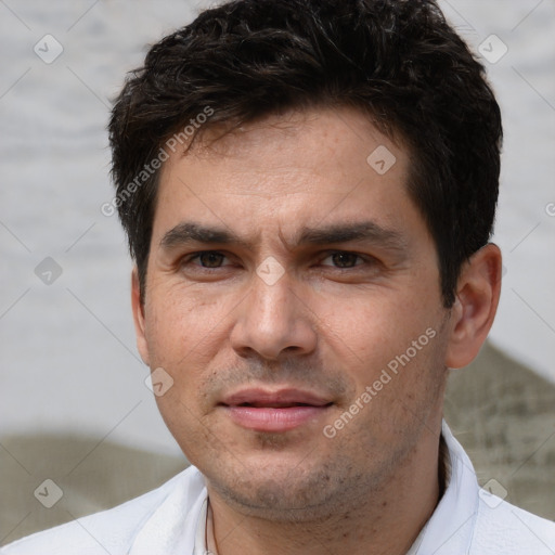 Joyful white young-adult male with short  black hair and brown eyes