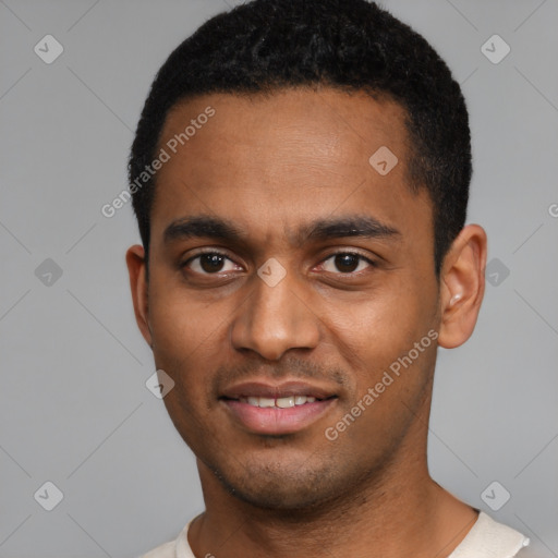 Joyful black young-adult male with short  black hair and brown eyes