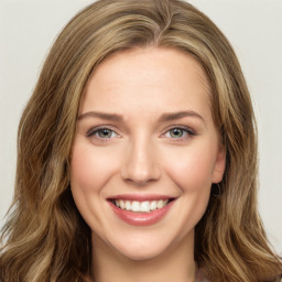 Joyful white young-adult female with long  brown hair and green eyes