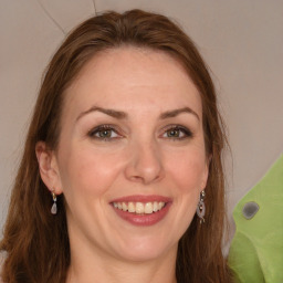 Joyful white adult female with long  brown hair and grey eyes