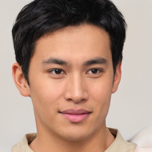 Joyful asian young-adult male with short  brown hair and brown eyes