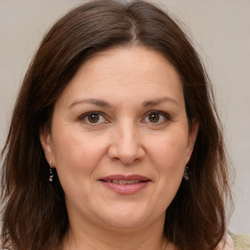 Joyful white adult female with medium  brown hair and brown eyes