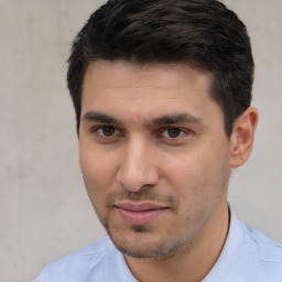 Joyful white young-adult male with short  black hair and brown eyes