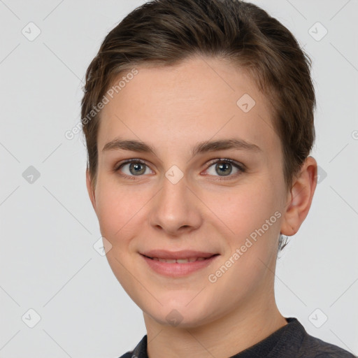 Joyful white young-adult female with short  brown hair and grey eyes