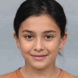 Joyful white child female with medium  brown hair and brown eyes