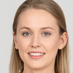 Joyful white young-adult female with long  brown hair and blue eyes