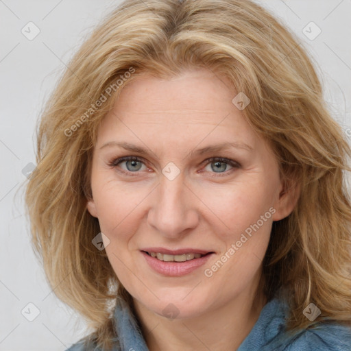 Joyful white adult female with medium  brown hair and blue eyes