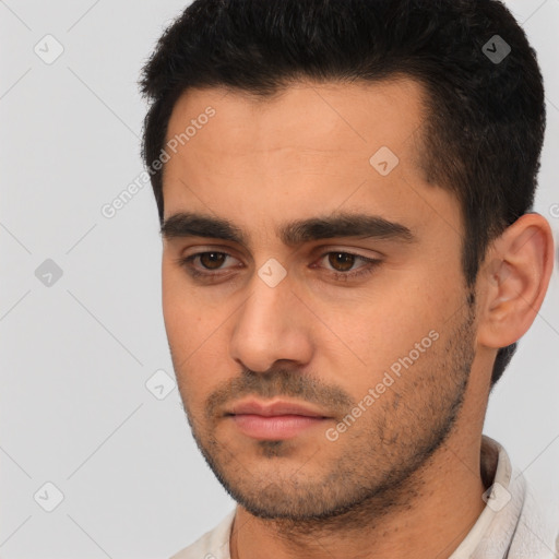 Joyful white young-adult male with short  black hair and brown eyes