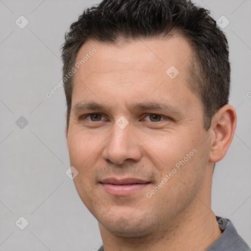 Joyful white adult male with short  brown hair and brown eyes