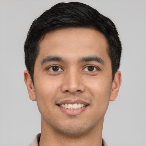 Joyful white young-adult male with short  black hair and brown eyes