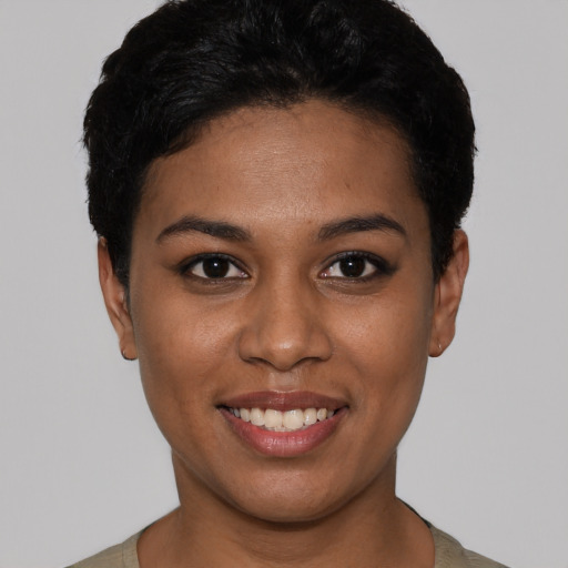 Joyful latino young-adult female with short  black hair and brown eyes