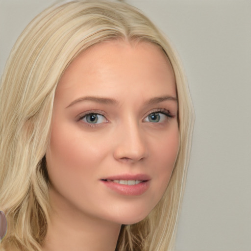 Joyful white young-adult female with long  blond hair and blue eyes