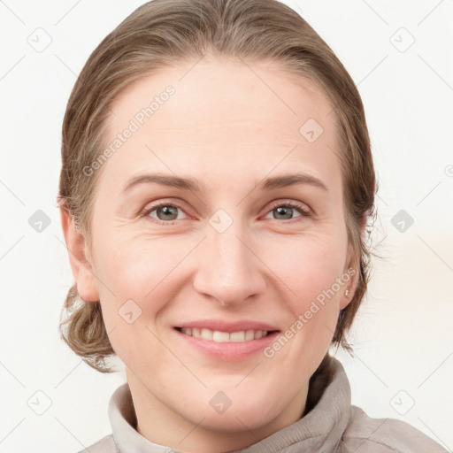 Joyful white young-adult female with medium  brown hair and grey eyes