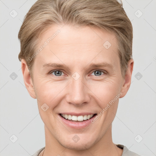 Joyful white adult female with short  brown hair and grey eyes