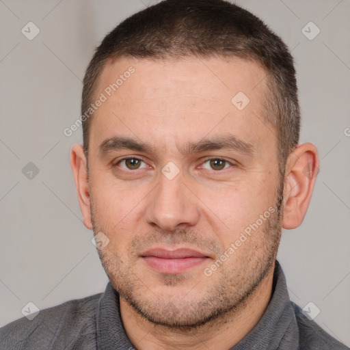 Joyful white adult male with short  brown hair and brown eyes