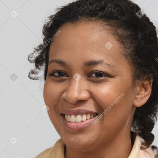 Joyful black young-adult female with medium  brown hair and brown eyes