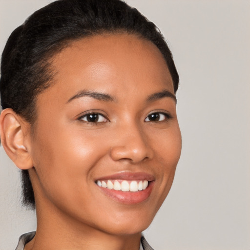 Joyful latino young-adult female with short  brown hair and brown eyes