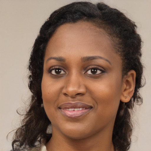 Joyful black young-adult female with medium  brown hair and brown eyes