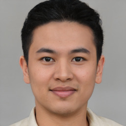 Joyful asian young-adult male with short  brown hair and brown eyes