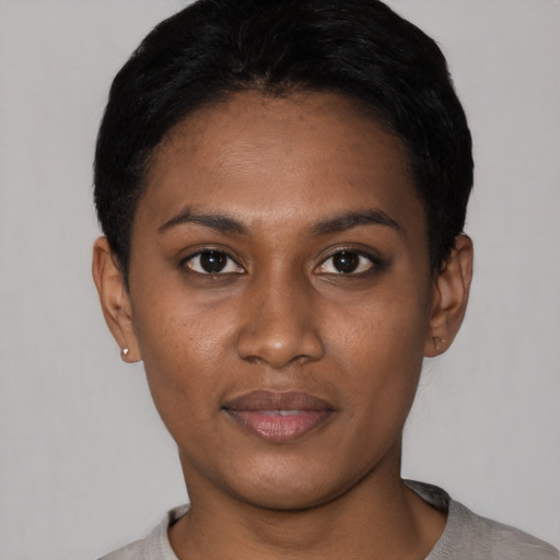Joyful latino young-adult female with short  black hair and brown eyes