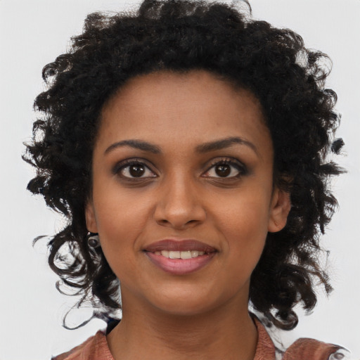 Joyful black young-adult female with medium  brown hair and brown eyes