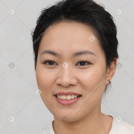 Joyful asian young-adult female with short  brown hair and brown eyes