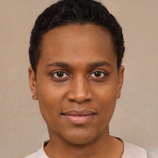 Joyful black young-adult female with short  black hair and brown eyes