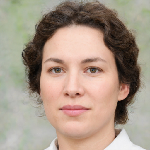Joyful white young-adult female with medium  brown hair and green eyes